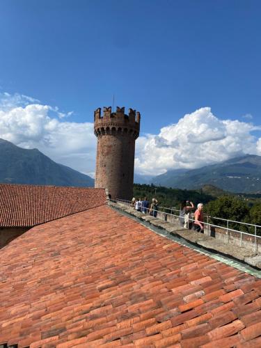 a group of people sitting on a brick roof at La mansarda di Orni in Ivrea