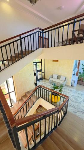 a staircase in a house with a living room at The Lantern Gardens - Oloirien in Kiserian