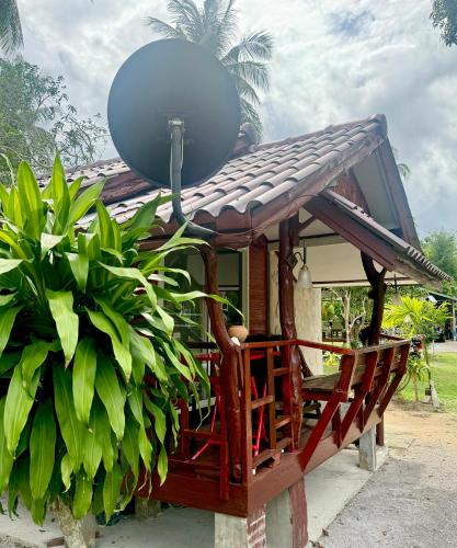 a house with a satellite dish on the roof at Wandee Resort Bankrut in Ban Krut