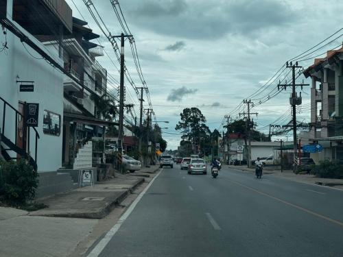 a city street with cars and motorcycles on the road at Serenity House 4A in Ban Nong Chaeng