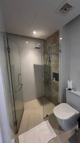 a bathroom with a glass shower and a toilet at The Lago apart Nai Harn beach 5min in Rawai Beach
