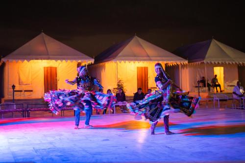 a group of people dancing on a stage at Happy Adventure Camp & Resort Sam Jaisalmer in Sām