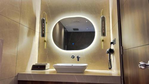 a bathroom with a sink and a mirror at FHotels in Bengaluru
