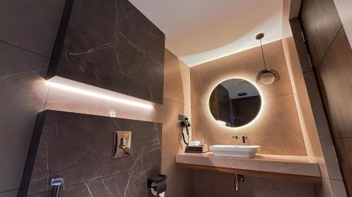 a bathroom with a sink and a mirror at FHotels in Bengaluru