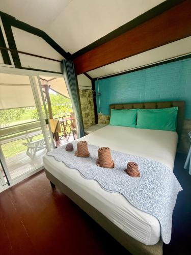 a bedroom with a bed with two baskets on it at Wandee Resort Bankrut in Ban Krut