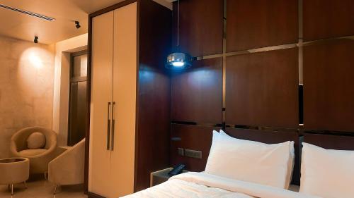 a bedroom with a bed with a wooden headboard at FHotels in Bengaluru