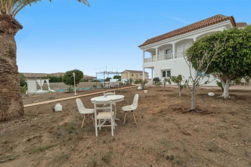a table and chairs in front of a house at Villa Luxury el Mirador in Adeje