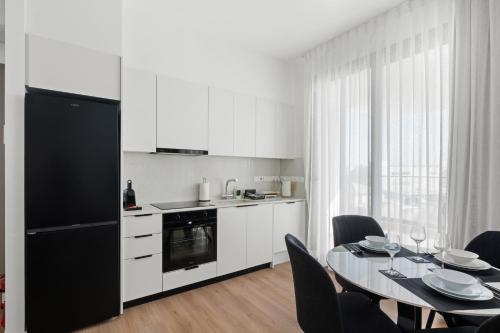 a kitchen and dining room with a table and chairs at Artemis 302 - Seaside Stories in Livadhia