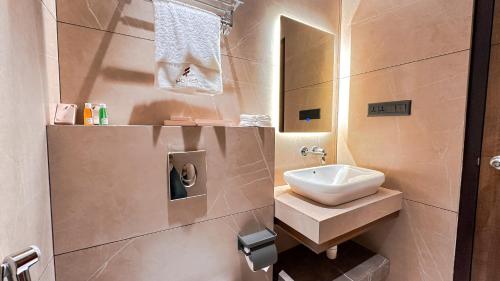 a bathroom with a sink and a mirror at FHotels in Bengaluru