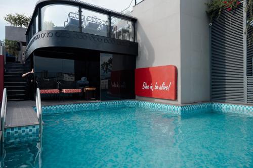 a swimming pool in front of a building at Champton Hanoi Hotel in Hanoi
