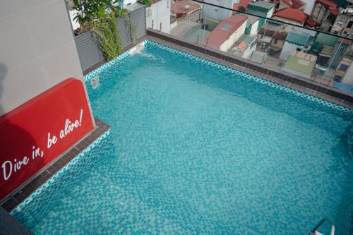 a large pool of blue water in a building at Champton Hanoi Hotel in Hanoi