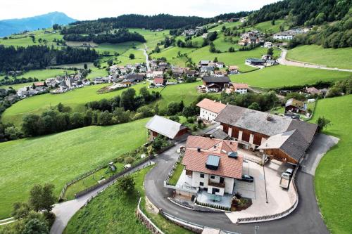 an aerial view of a village in the hills at Parliflhof Apt Langfenn in Meltina