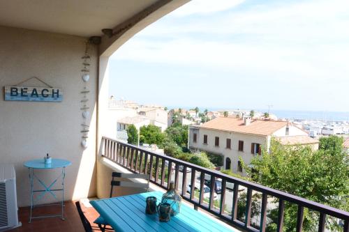 a balcony with a table and a view of a city at DOLCE VITA in Kamiesch