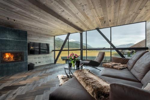 a living room with a couch and a fireplace at Black Diamond Chalet in Mils bei Hall