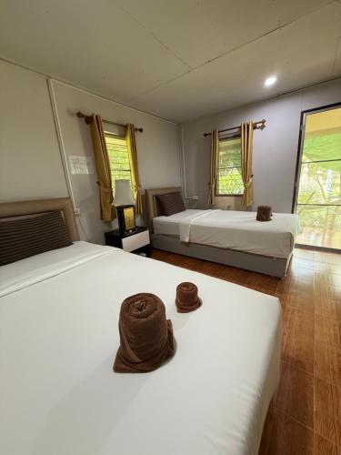 a bedroom with two beds with towels on them at Wandee Resort Bankrut in Ban Krut