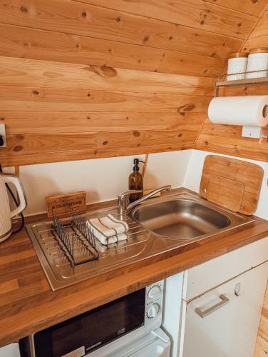 a kitchen with a sink in a tiny house at Strathyre Camping Pods in Strathyre