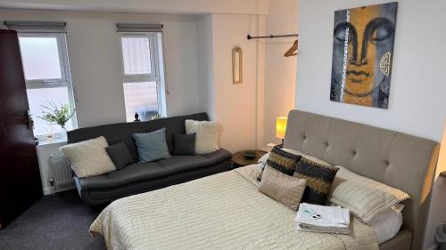 a living room with a bed and a couch at SOBO Studio in Bournemouth