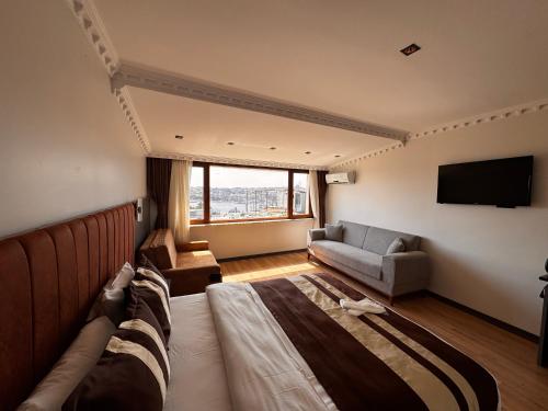 a hotel room with a bed and a couch at Blue Istanbul Hotel Taksim in Istanbul