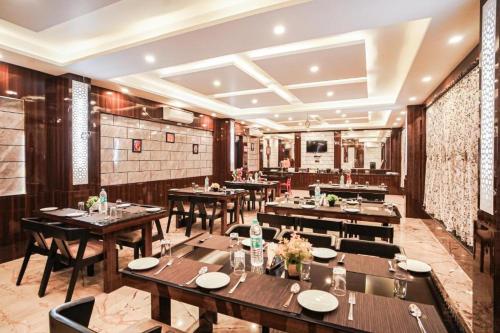 a dining room with wooden tables and chairs at The Rath Inns in Mandarmoni