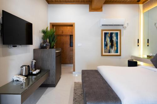 Ένα ή περισσότερα κρεβάτια σε δωμάτιο στο GreenPak Kalam Resort