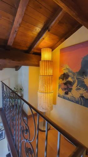 a staircase with a lamp and a painting on the wall at Antica Rupe Casa Vacanze in Castel SantʼElia