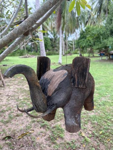 a statue of an elephant chained to a tree at Wandee Resort Bankrut in Ban Krut