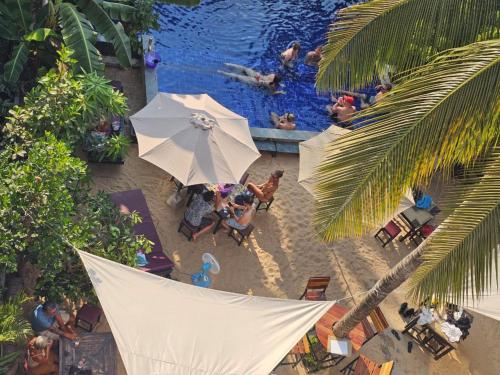 an overhead view of a pool with people at a resort at Angkor Legacy Boutique in Siem Reap
