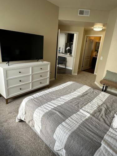 a bedroom with a bed and a flat screen tv at Spacious 2B 2B Pool View Loft Apartment in Marina Del Rey in Los Angeles