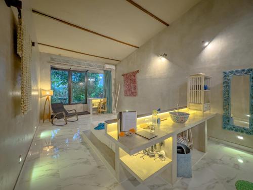 a large room with a counter and a table in it at Gunung An Retreat in Ubud