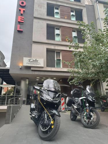 two motorcycles parked in front of a building at Hotel Dolce International in Skopje