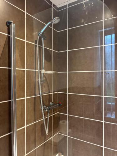 a shower with a shower head in a bathroom at Thistle Tide 13 Nelson Street Largs KA308LN 1st Floor in Largs