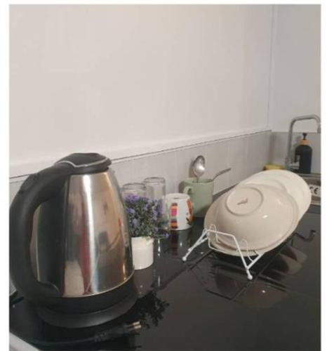 a kitchen counter with a tea kettle on a stove at Popular Muang Thong Thani Condo, Building T9, Floor 4, Room 36 in Thung Si Kan