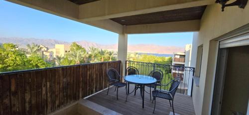 a patio with a table and chairs on a balcony at New on site !! cozy apartment with full sea view in Eilat