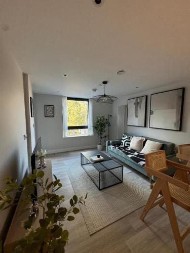 a living room with a couch and a table at Apartment with Terrace in Uxbridge in Uxbridge