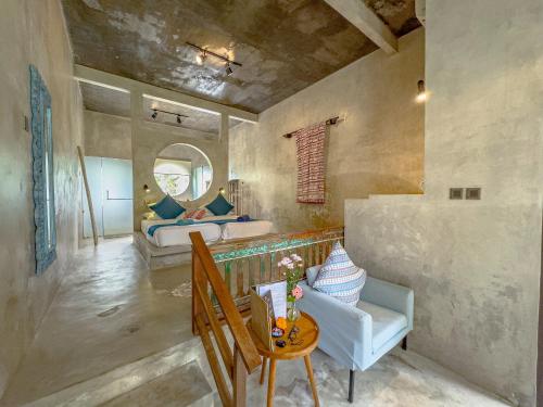 a room with a bed and a table and a chair at Gunung An Retreat in Ubud