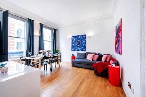 a living room with a couch and a table at Welcome London Covent Garden Piazza in London
