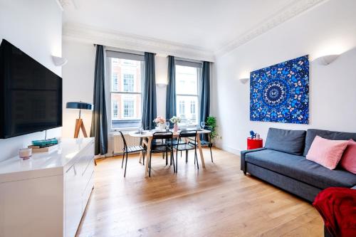 a living room with a couch and a table at Welcome London Covent Garden Piazza in London