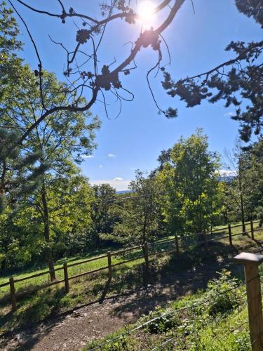 a view of a fence with the sun in the sky at Mas Al Parry in Saint-Marsal