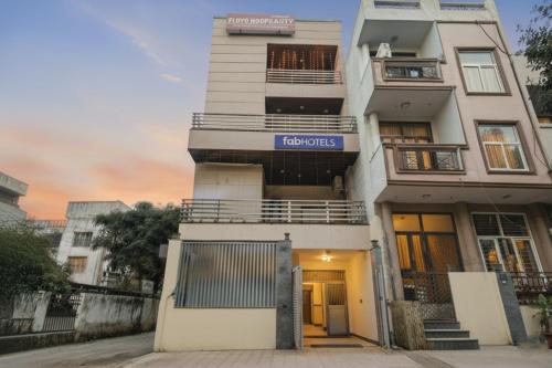 a tall white building with a sign on it at FabHotel F-Aloyd Lajpat Nagar in New Delhi