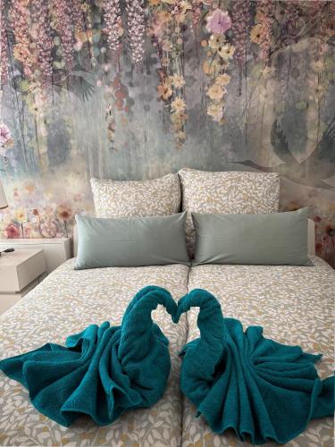 a bed with two blue towels laying on it at Palazzo Verde in Würzburg in Würzburg