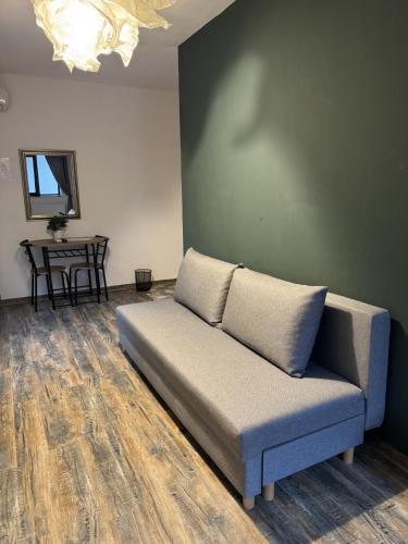 a couch in a living room with a table at La Livada in Otopeni