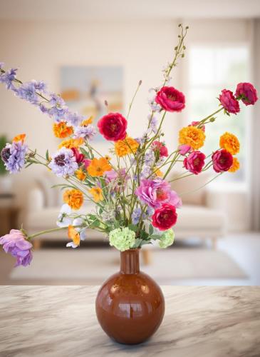 a brown vase filled with colorful flowers on a table at Palazzo Verde in Würzburg in Würzburg