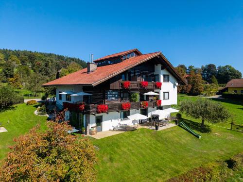 a large white house with a red roof at Erlebnishaus Spiess in Feldkirchen in Kärnten
