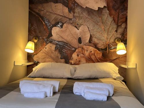 a bedroom with a large bed with two pillows at Acogedor Apartamento en Cudillero in Cudillero
