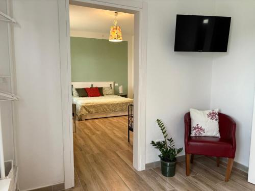 a room with a bedroom with a bed and a mirror at B&B Il giardino segreto in Guarda Ferrarese