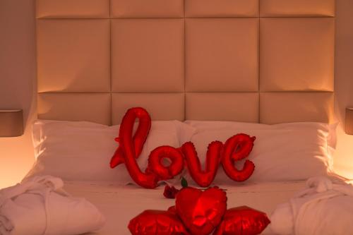 a bed with the word love written on it at Alma Suites - Il Nido d'Amore in Livorno