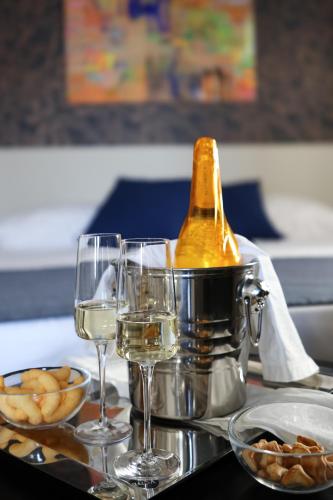 a table with two glasses and a bottle of wine at It's Room Naples in Naples