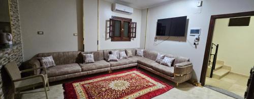 a living room with a couch and a rug at La Terrace in Aswan