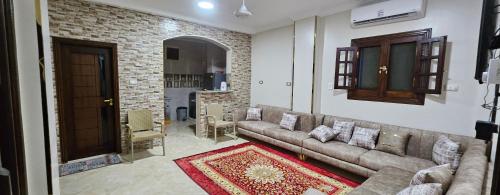 a living room with a couch and a brick wall at La Terrace in Aswan