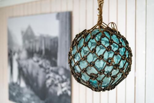 a blue ornament hanging on a wall next to a picture at Ure Lodge in Sennesvik